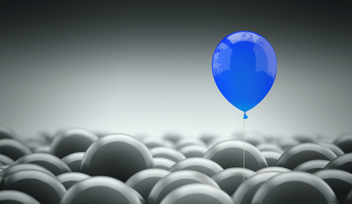 Blue Balloon rising about a sea of white ballons